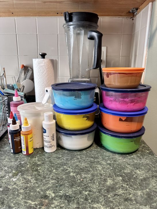 picture of several glass pyrex bowls with plastic lids used for storing royal icing 