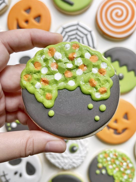 cauldron cookie decorated with dark grey royal icing 