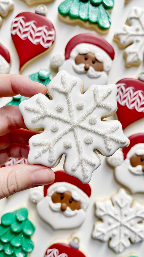 snowflake cookie decorated with royal icing 