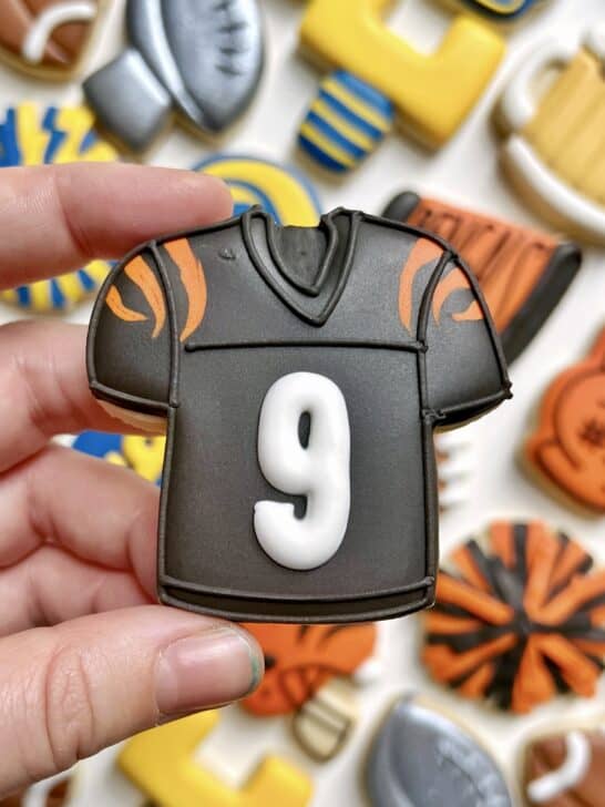 black jersey cookie decorated with black royal icing