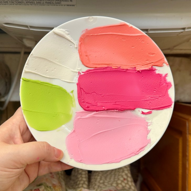 royal icing colors on a white plate 