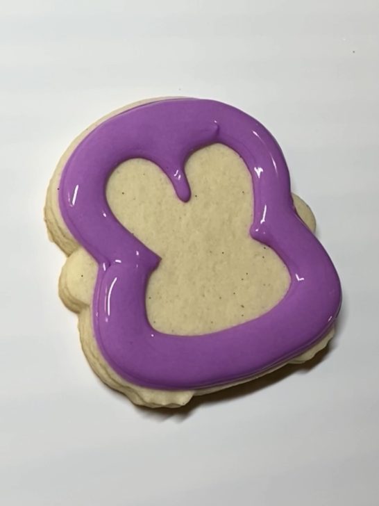 decorating penguin cookies with royal icing