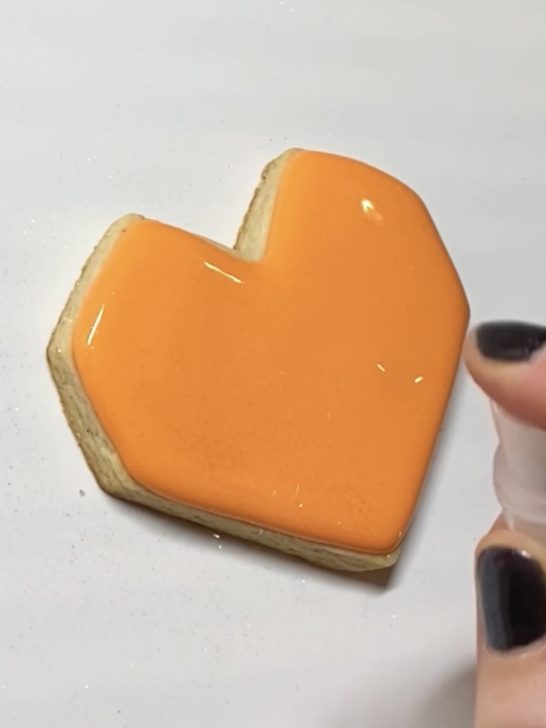 step 2 of decorating heart cookies with royal icing