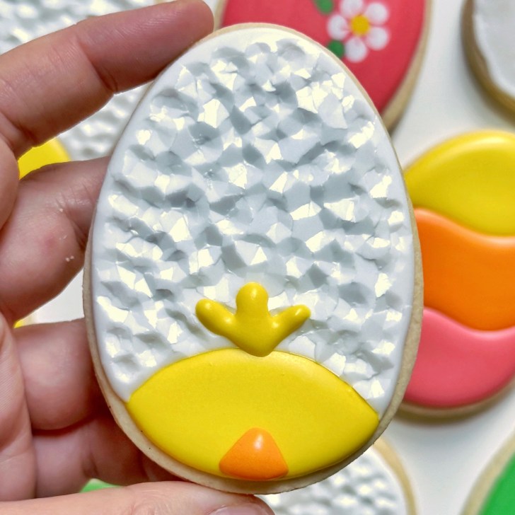 chick easter egg cookie decorated with royal icing