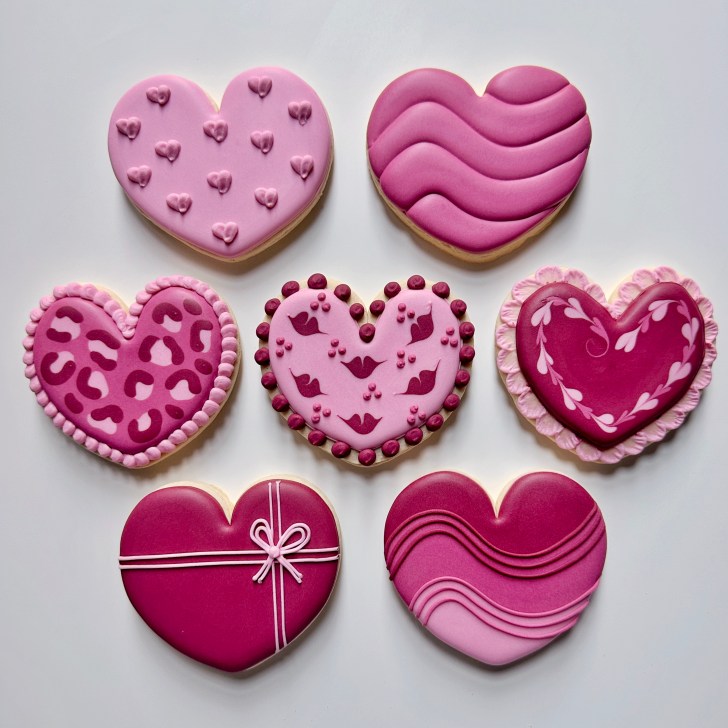 8 heart cookies decorated with royal icing
