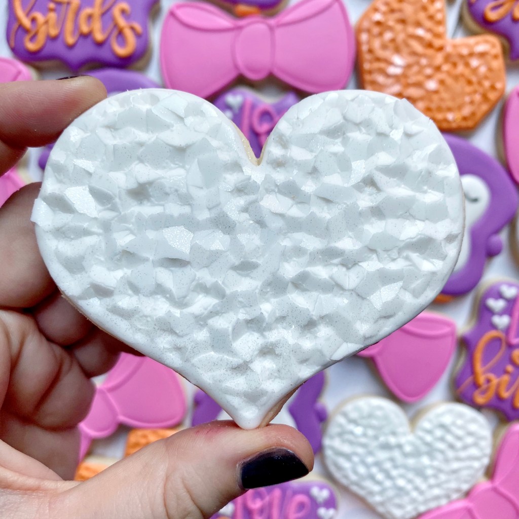 photo of white heart cookies decorated with royal icing